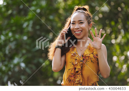Pretty young woman talking on phone 43004633