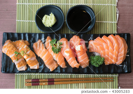 Mixed salmon sushi on black plate in restaurant Mixed salmon sushi on black plate in restaurant 43005283