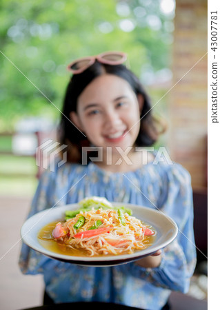 Young asain girl holding papa salad Young asain girl holding papa salad 43007781