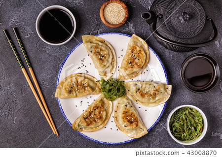 Gyoza or dumplings snack with soy sauce. Gyoza or dumplings snack with soy sauce. 43008870
