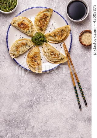 Gyoza or dumplings snack with soy sauce. Gyoza or dumplings snack with soy sauce. 43008875