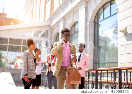 positive guy is talking with parents while his friends are having a conversation positive guy is talking with parents while his friends are having a conversation 43009265