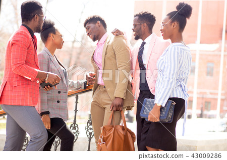 macho guy is flirting with female colleague in front of co-workers macho guy is flirting with female colleague in front of co-workers 43009286