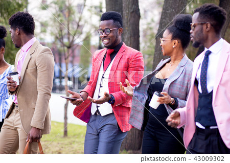 stylish african guy is telling a funny stories to his friend stylish african guy is telling a funny stories to his friend 43009302