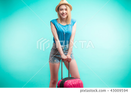 charming girl is leaning on the pink luggage charming girl is leaning on the pink luggage 43009594