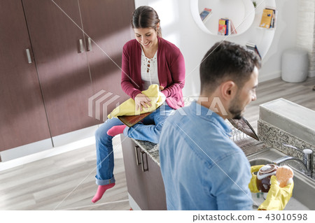 Man And Woman Doing Home Chores In Kitchen Man And Woman Doing Home Chores In Kitchen 43010598