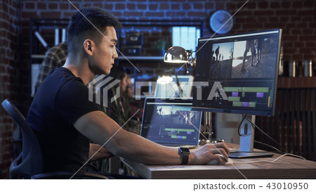Ethnic man editing video on computer Ethnic man editing video on computer 43010950