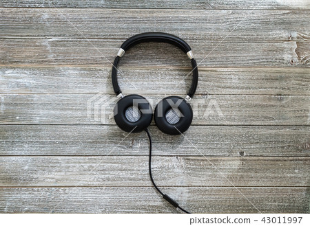 Headphones on a wooden desk Headphones on a wooden desk 43011997
