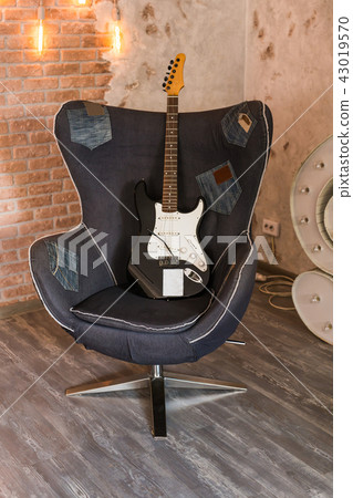 Electric guitar on a chair Electric guitar on a chair 43019570