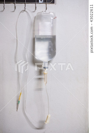 Saline solution iv bag with syringe line hanging 43022611