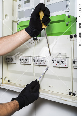 Electrician repairs distribution board close up Electrician repairs distribution board close up 43023382