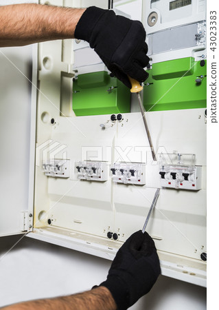 Electrician repairs distribution board Electrician repairs distribution board 43023383