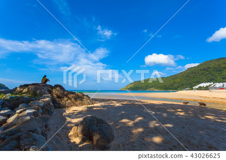 a tourist sitting on the rock a tourist sitting on the rock 43026625
