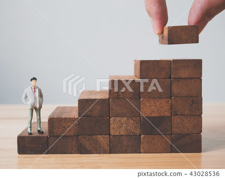 Hand arranging wood block stacking as step stair Hand arranging wood block stacking as step stair 43028536