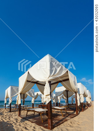 Beach canopies on white sandy beach Beach canopies on white sandy beach 43032093