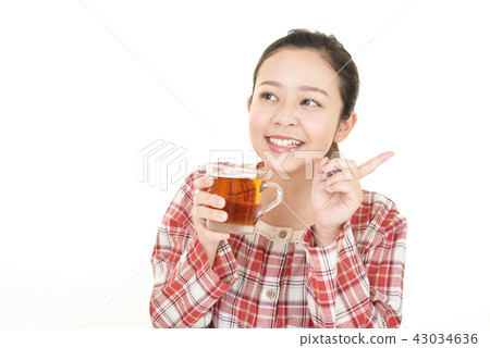 A woman drinking tea A woman drinking tea 43034636