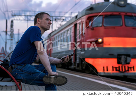 Man at the train station with a phone Man at the train station with a phone 43040345