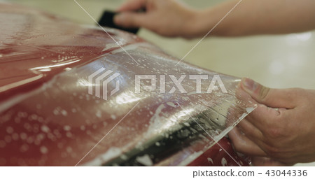 professional applying protective film to the red car professional applying protective film to the red car 43044336