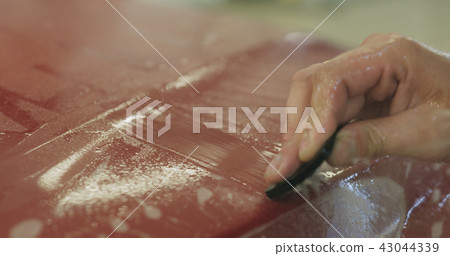 professional applying protective film to the red car professional applying protective film to the red car 43044339