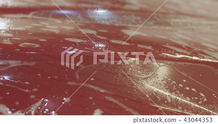 applying protective film to the red car applying protective film to the red car 43044353