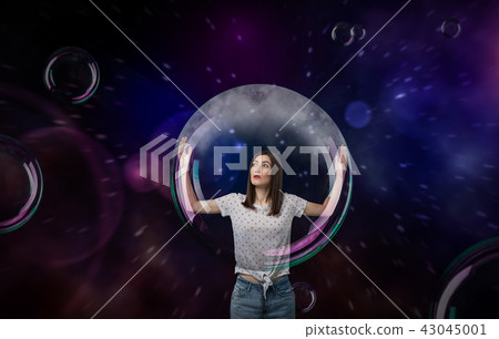 Pretty woman with big soap bubble 43045001