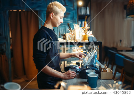Barista hand pours beverage from coffee machine Barista hand pours beverage from coffee machine 43045893