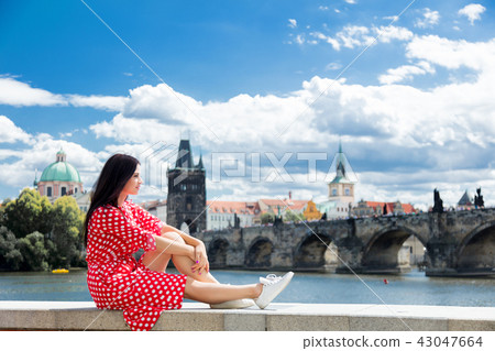 Beautiful girl in red dress travel in Prague 43047664