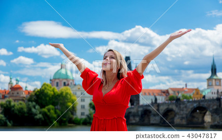 Beautiful girl in red dress travel in Prague 43047817
