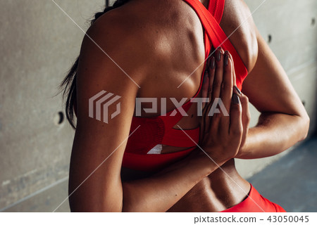 Close up fit woman with arms behind back doing stretching exercises. Close up fit woman with arms behind back doing stretching exercises. 43050045
