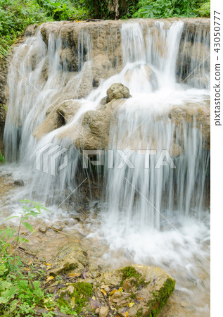 small waterfall in green nature park 43050777