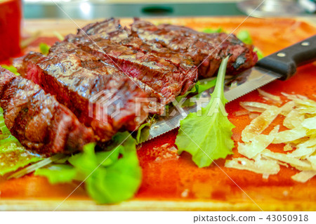 Traditional Italian Tagliata Steak with Parmesan and Salad as close-up on a plate Traditional Italian Tagliata Steak with Parmesan and Salad as close-up on a plate 43050918