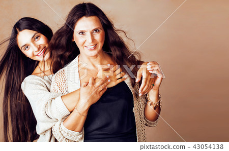 cute pretty teen daughter with mature mother hugging, fashion st cute pretty teen daughter with mature mother hugging, fashion st 43054138