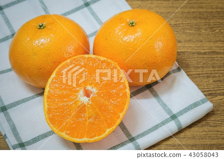 Ripe and Sweet Oranges on A Wooden Table 43058043