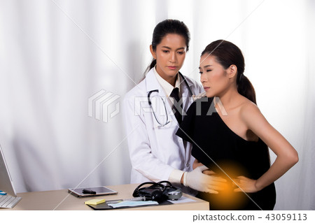Asian Patient was checked health by india middle east Doctor woman in uniform with stethoscope, rubber gloves in Medical hospital clinic, concept pain hurt inside stomach belly Digestive, copy space Asian Patient was checked health by india middle east Doctor woman in uniform with stethoscope, rubber gloves in Medical hospital clinic, concept pain hurt inside stomach belly Digestive, copy space 43059113