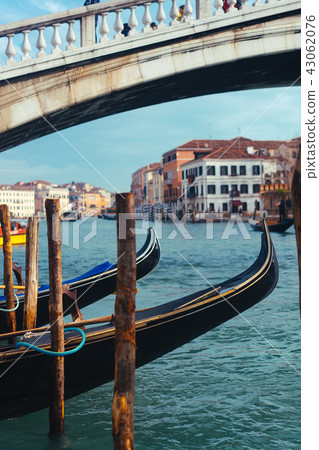 Venetian channel with ancient houses and boats Venetian channel with ancient houses and boats 43062076