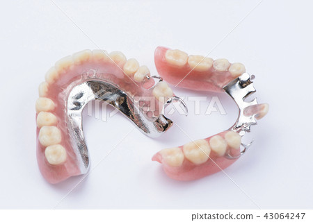 Removable metal partial denture on white backgroun Removable metal partial denture on white backgroun 43064247