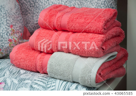 closeup of red bath towels pile in store showroom closeup of red bath towels pile in store showroom 43065585