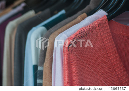 pullover on hangers in a woman fashion store pullover on hangers in a woman fashion store 43065587