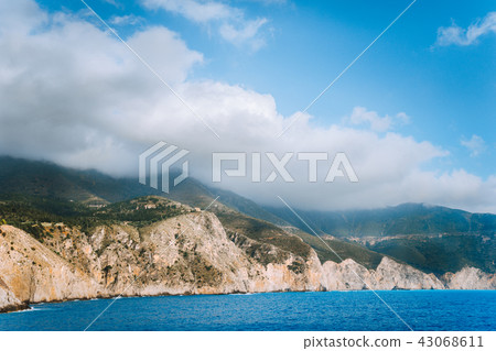 Picturesque rocky coastline on Kefalonia island. Amazing landscape in soft light with cloudscape Picturesque rocky coastline on Kefalonia island. Amazing landscape in soft light with cloudscape 43068611
