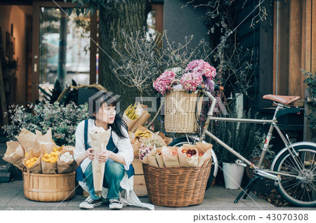 A woman in a flower shop A woman in a flower shop 43070308