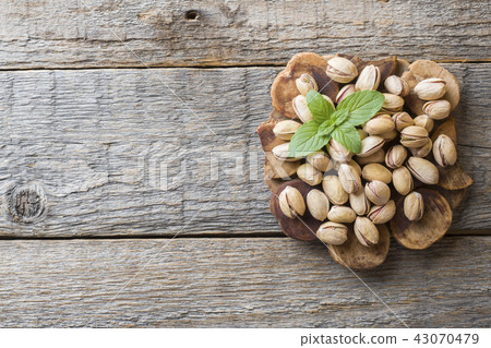 Delicious salted pistachios and fresh mint leaves  43070479