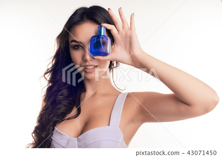 Portrait of beautiful girl with bottle of perfume 43071450
