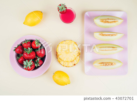 Fresh strawberries in bowl and melone on pastel yellow background. 43072701