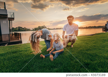 Happy parents spending time with kid outside 43073189