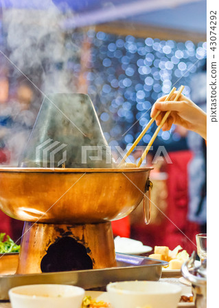 Chinese Traditional hot pot. Eating chopsticks Chinese Traditional hot pot. Eating chopsticks 43074292