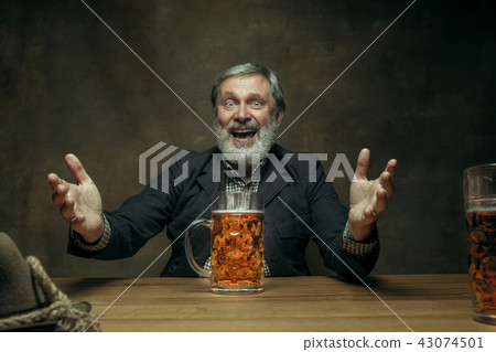 Smiling bearded male drinking beer in pub 43074501