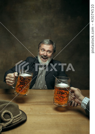 Smiling bearded male drinking beer in pub 43074510