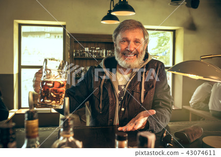 The senior bearded male drinking beer in pub 43074611