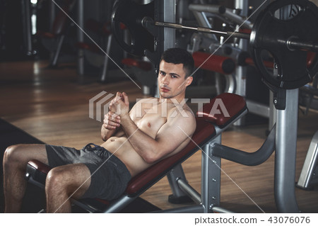 Ambitious athlete is training with equipment indoors Ambitious athlete is training with equipment indoors 43076076