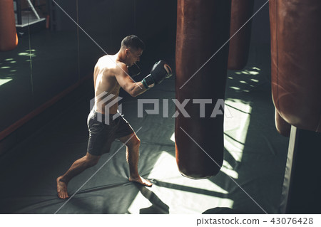 Sportsman is training jab kick in gym 43076428